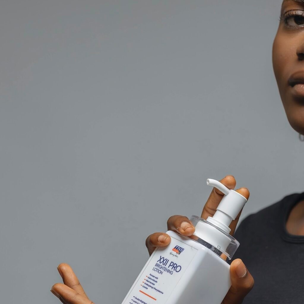 Image of a model holding up a tns skincare product