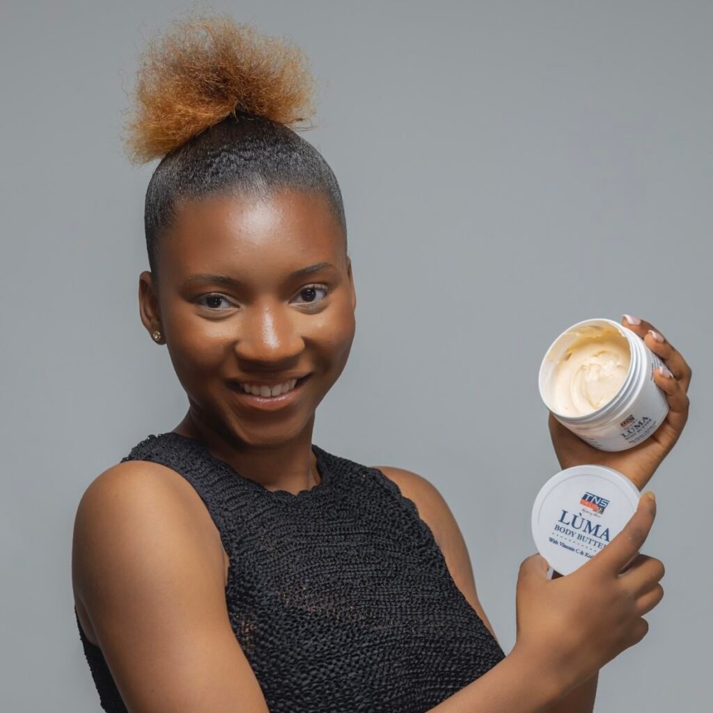 Image of a pretty model holding up a tns skincare product